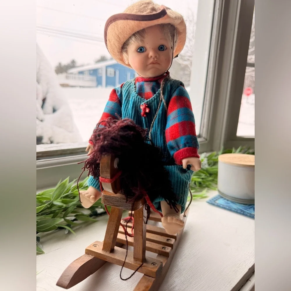 Doll in Striped Outfit on Rocking Horse